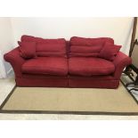 A modern red upholstered two seat sofa, 220 cm wide x 90 cm deep x 80 cm high