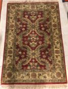 A Chobli rug, the central panel set with foliate decoration on a burgundy ground, within a stepped