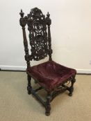 A 19th Century walnut framed hall chair in the Carolean taste, the shell and scroll work carved back