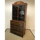 A Regency mahogany secretaire bookcase, the domed cornice with inlaid elongated octagonal panel over