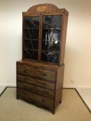 A Regency mahogany secretaire bookcase, the domed cornice with inlaid elongated octagonal panel over