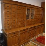 A 19th Century Austro-Hungarian pine apothecary or chemist's cabinet, the upper section with two