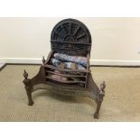 A 20th Century steel and cast iron fire basket in the Regency taste with integral fan decorated back