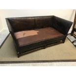 A Victorian studded leather upholstered sofa in the 17th Century manner, raised on turned and
