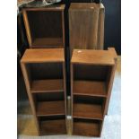 A suite of oak open bookshelves, some with sliding doors, others with pigeon holes
