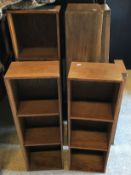 A suite of oak open bookshelves, some with sliding doors, others with pigeon holes