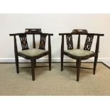 Two Edwardian mahogany and inlaid yoke back corner chairs of typical form