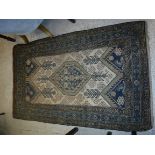 A Caucasian rug, the central panel set with lozenge shaped medallion on a cream ground, with