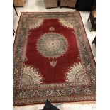 A large fine Oriental carpet, the central panel set with floral decorated circular medallion on a