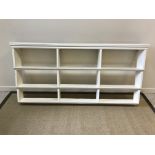 A Victorian white painted three tier set of graduated wall shelves (possibly nursery bookshelves),