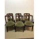 A set of six Victorian carved walnut framed shaped back dining chairs in the Aesthetic taste, raised