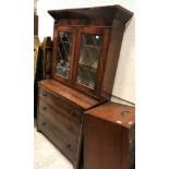 A 19th Century figured mahogany secretaire bookcase, the upper section with canted cornice over
