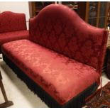 A modern red damask upholstered banquette, the back with serpentine top rail, the seat with