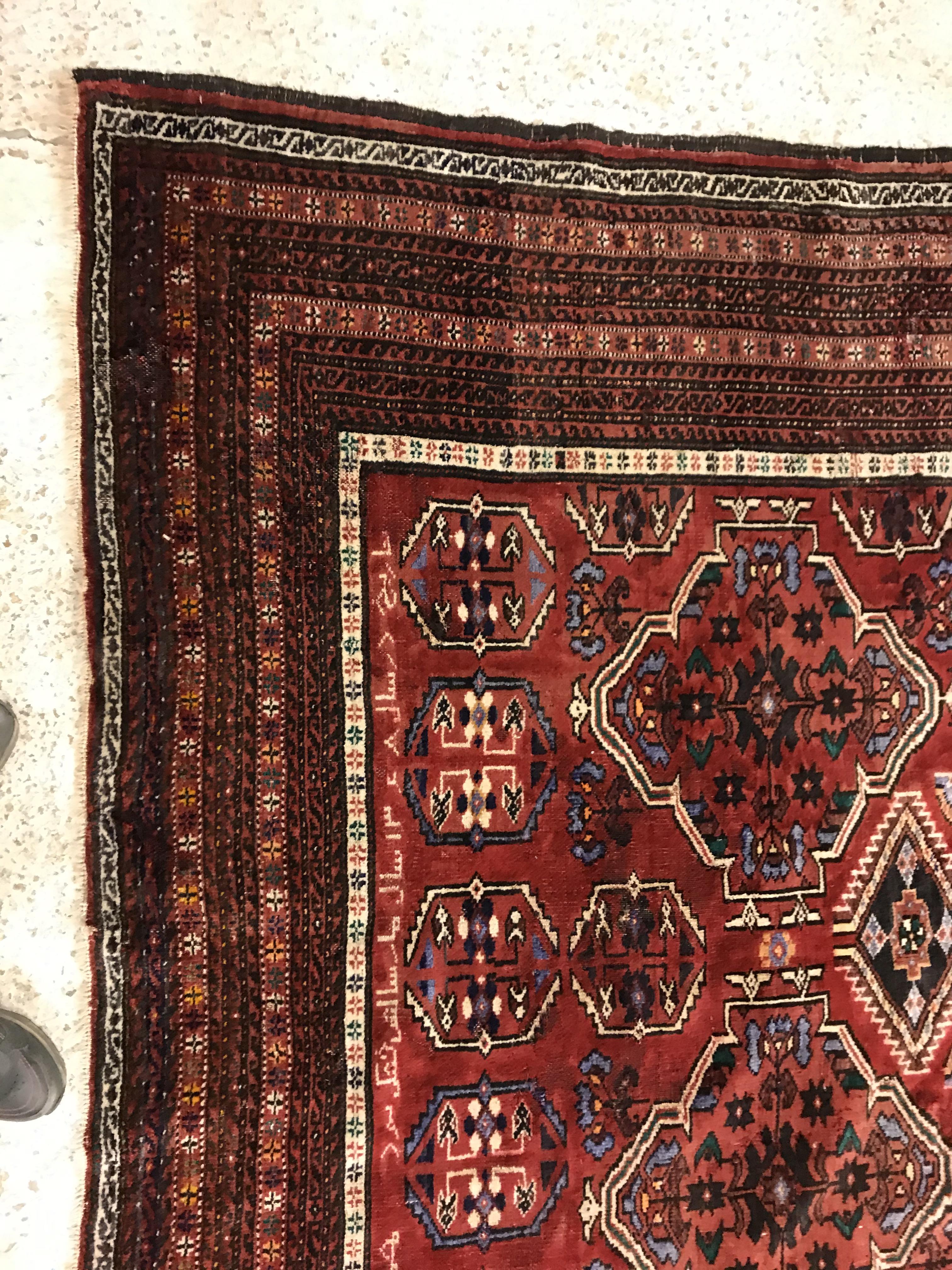 A Caucasian carpet, the central panel set with repeating medallion decoration on a blood red - Image 3 of 15