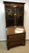 An Edwardian mahogany and barber pole banded bureau bookcase, the upper section with two glazed