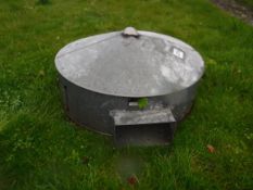 A galvanised chicken heater of circular form