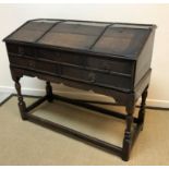 An oak clerk's desk in the 18th Century manner, the plain top above a sloping fall with reeded