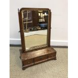 A 19th Century mahogany and barber pole strung toilet mirror, the shallow dome top plate with carved