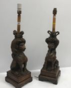 A pair of 17th Century carved oak newel post finials as a crowned lion and unicorn, both seated upon