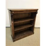 A Victorian mahogany open bookcase with scrolling foliate carved corbels on a plinth base, 83.5 cm