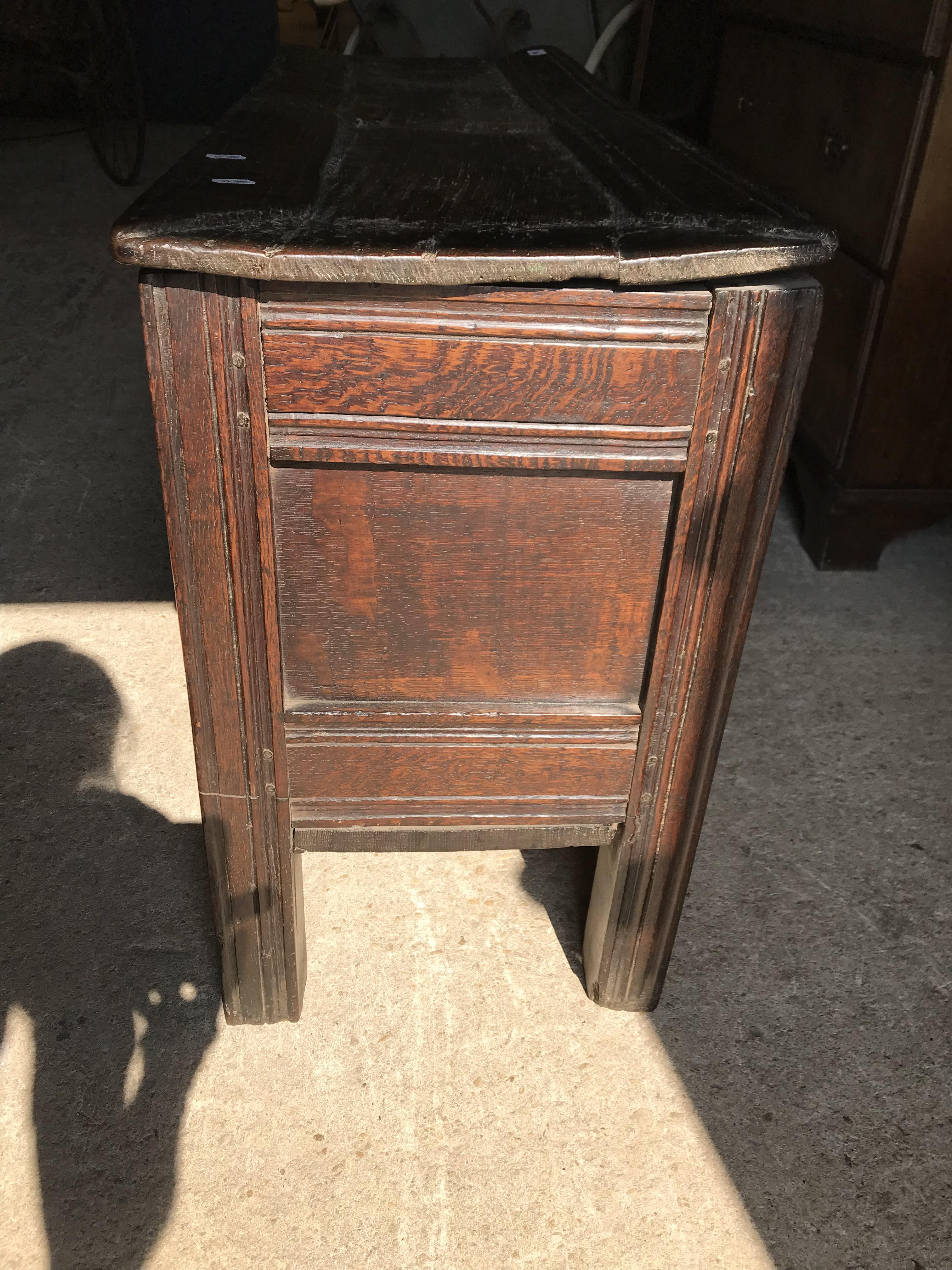 An 18th Century oak coffer, the single piece carved plank top over a three panel front with - Image 9 of 24