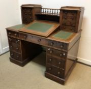 A late Victorian mahogany "Dickens" desk, the superstructure with central writing slope flanked by