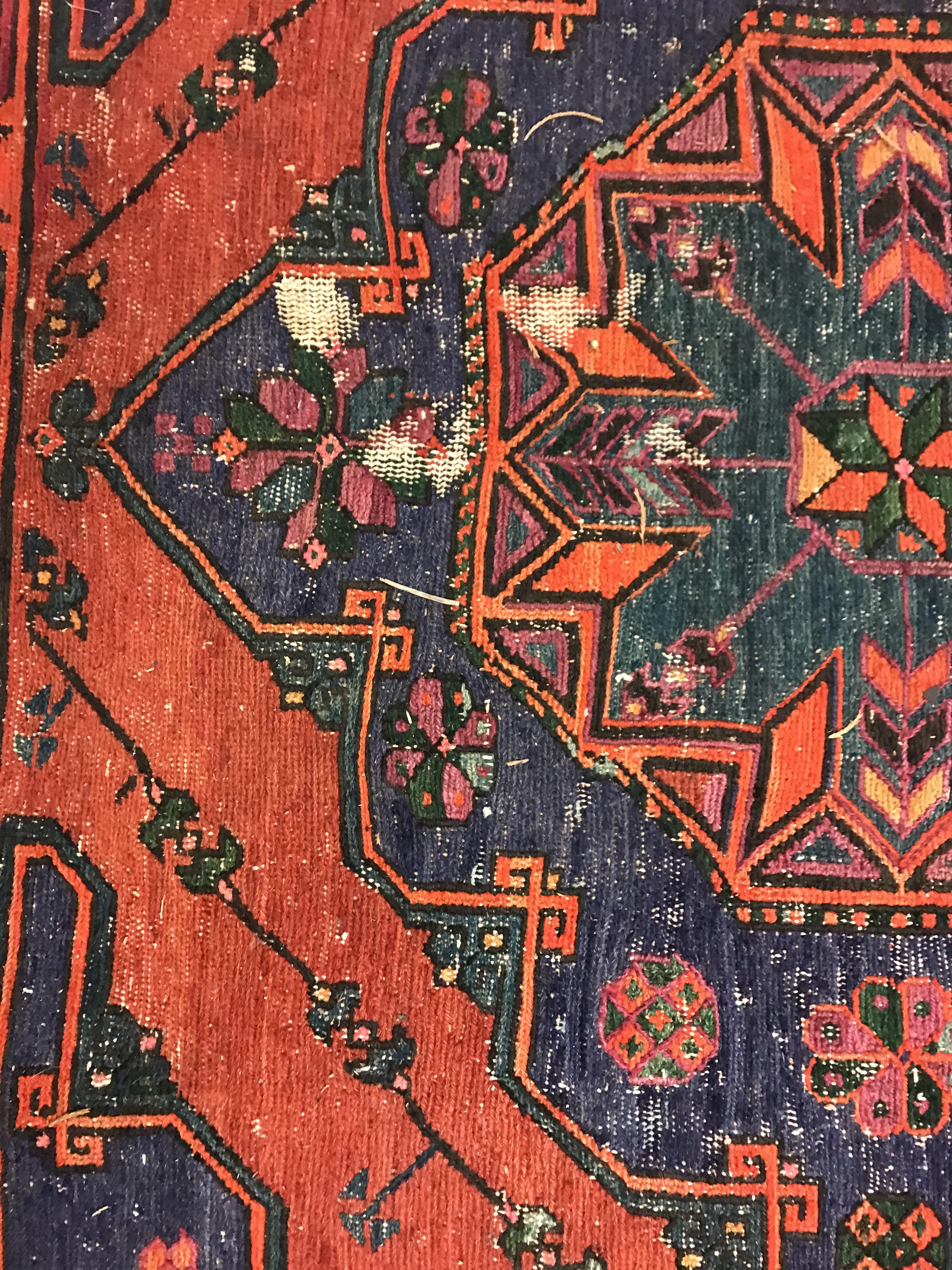 A Persian rug with three repeating lozenge medallions on a red and blue ground, within a blue, red - Image 15 of 20