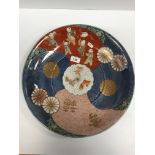 A circa 1900 Japanese Arita charger, the centre field decorated with panels of children in