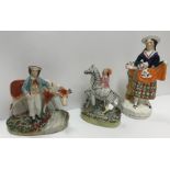 A collection of thirteen Victorian Staffordshire pottery figures including a pair of Spaniels, "Girl