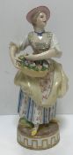 A 19th Century Meissen figure of woman with basket of flowers, bearing Marcolini period style blue