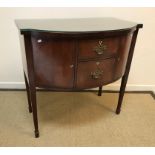 An Edwardian mahogany bow fronted sideboard, the cross-banded and barber pole strung top over two