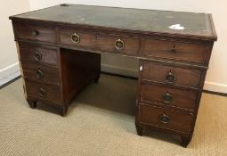 An early 19th Century mahogany double pedestal desk, the tooled and silvered leather insert top over