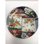 A circa 1900 Japanese Imari charger, the centre field decorated with folded scroll depicting a