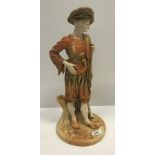 A Royal Worcester buff ware porcelain figure of a Turk with rifle stood by a tree trunk, No'd. 2038,
