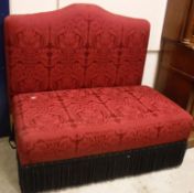 A modern red damask upholstered banquette, the back with serpentine top rail, the seat with
