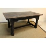 An oak refectory table in the 17th Century manner, the three plank top with cleated ends above a