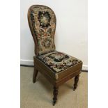 A Victorian walnut framed spoon back prie a dieu type chair, the back and seat with needlework