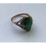 WITHDRAWN A gold mounted imperial jade ring of elongated hexagonal or lozenge form approx. 15 mm x 8