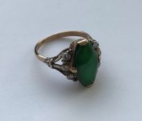 WITHDRAWN A gold mounted imperial jade ring of elongated hexagonal or lozenge form approx. 15 mm x 8