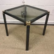 A modern coffee table, the circular glass top raised on a cast metal tripod base, 90 cm diameter x