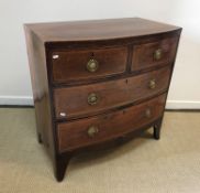 A 19th Century mahogany and satinwood strung bow fronted chest of two short over two long drawers on