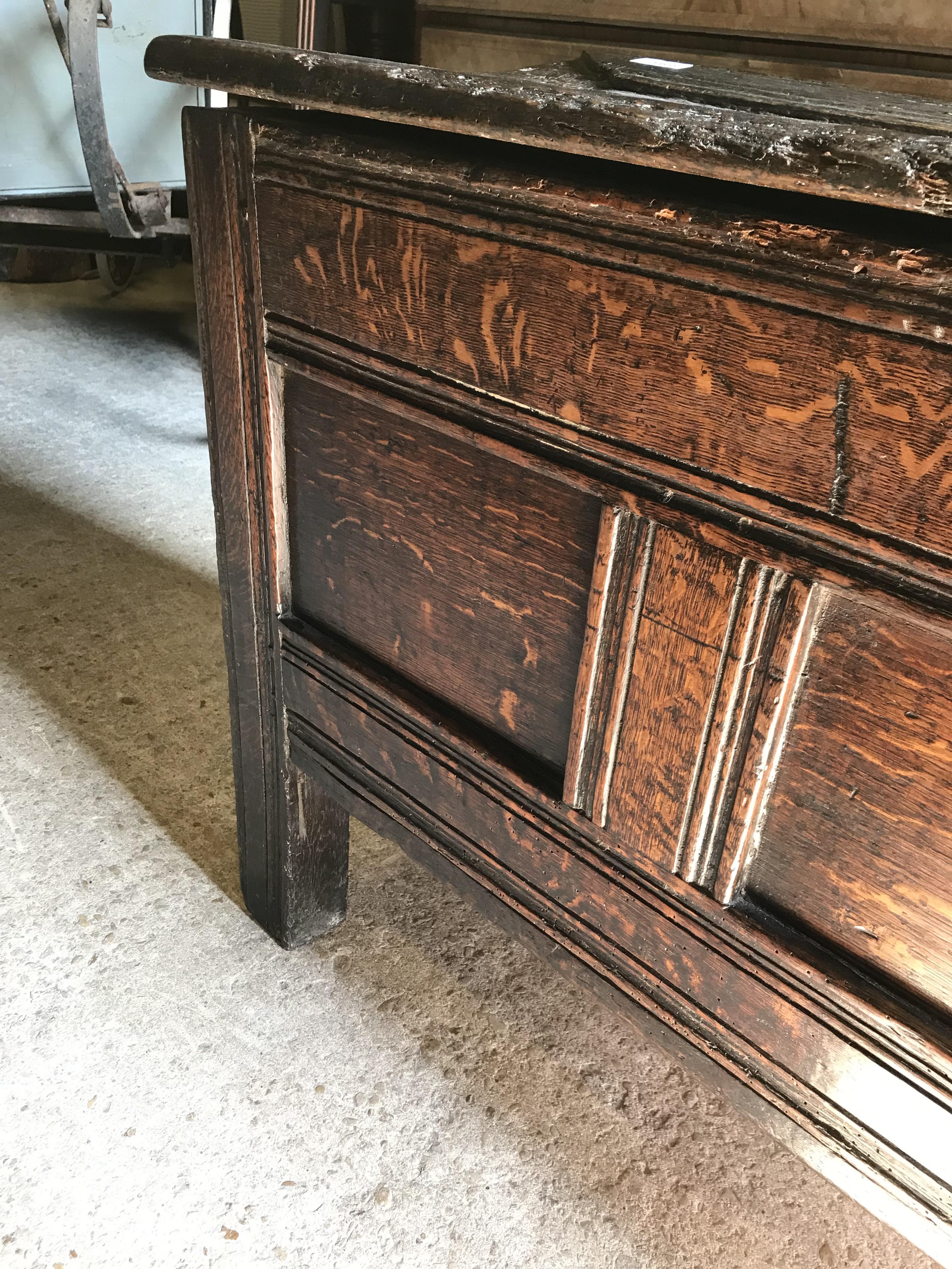 An 18th Century oak coffer, the single piece carved plank top over a three panel front with - Image 6 of 24