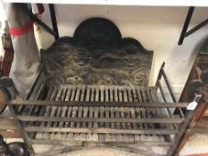 A heavy cast iron fire back in the 17th Century manner decorated with lion passant and symbols of