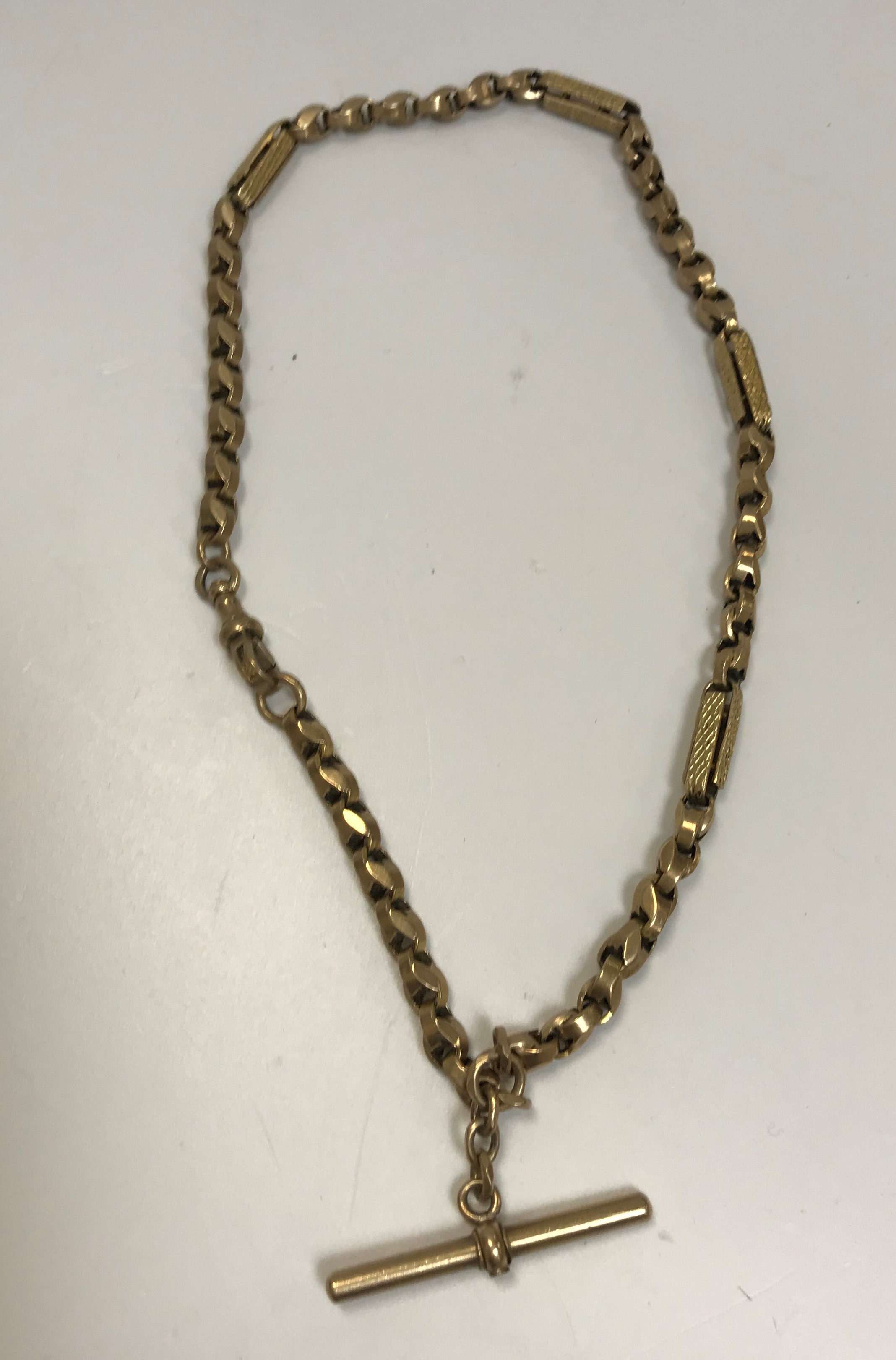 A 9 carat gold fancy chainlink watch chain with T bar approx. 36 cm long 21 g