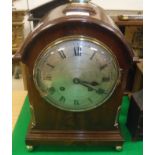 A Victorian mahogany cased mantel clock, the domed top with brass handle, the eight day movement