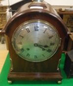 A Victorian mahogany cased mantel clock, the domed top with brass handle, the eight day movement