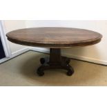A Victorian rosewood centre table, the oval top with moulded edge above a plain frieze on tapering