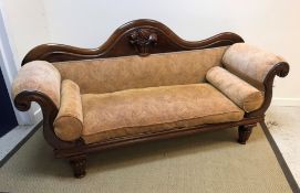 A Victorian mahogany framed scroll arm sofa, the show frame with fruit and floral carved back raised
