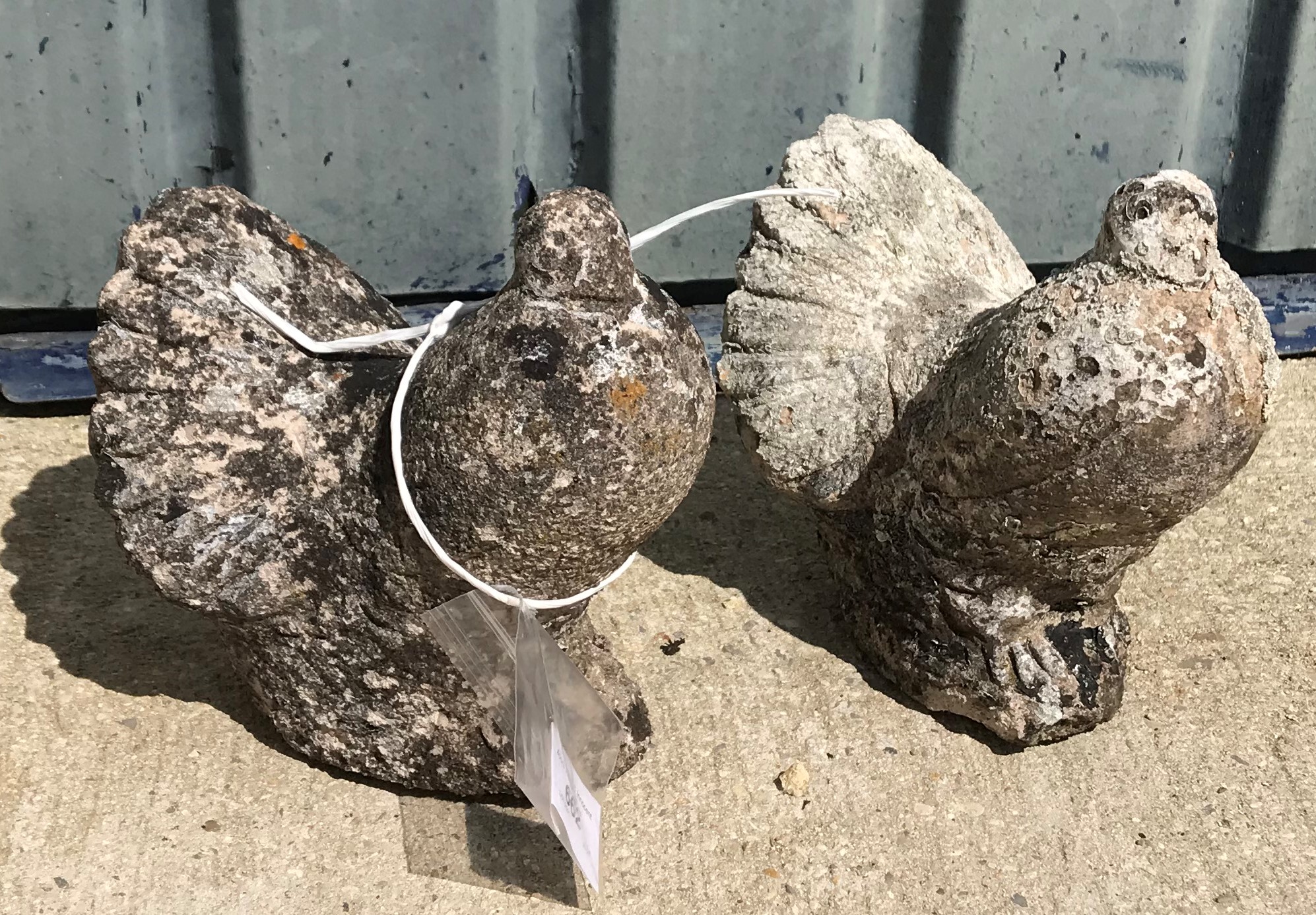 Two natural stone carved figures of fan tail pigeons approx. 20 cm high