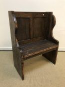An oak and pine single seat pew or hall bench, the twin panel back over a single plank seat,
